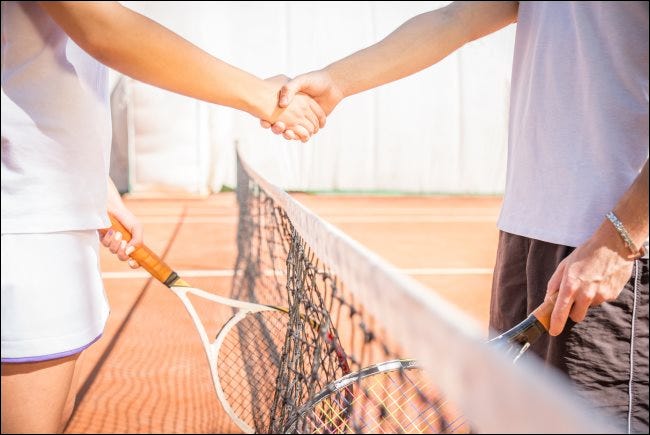 Deux joueurs se serrant la main sur un court de tennis